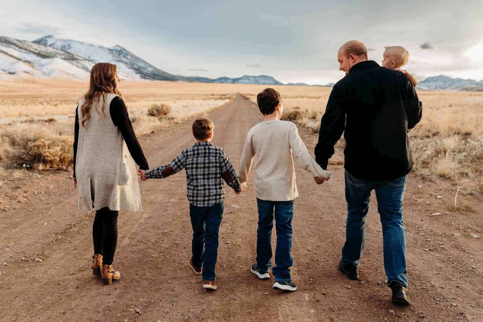 a family of 5 walking in the foothills of the Utah mountains.