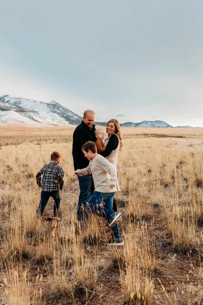 A family of 5 dancing in the foothills nestled against the Utah mountains. 