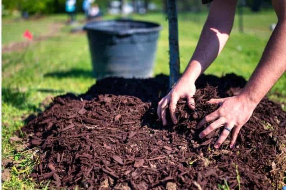 Hands mixing Utah soil. 
