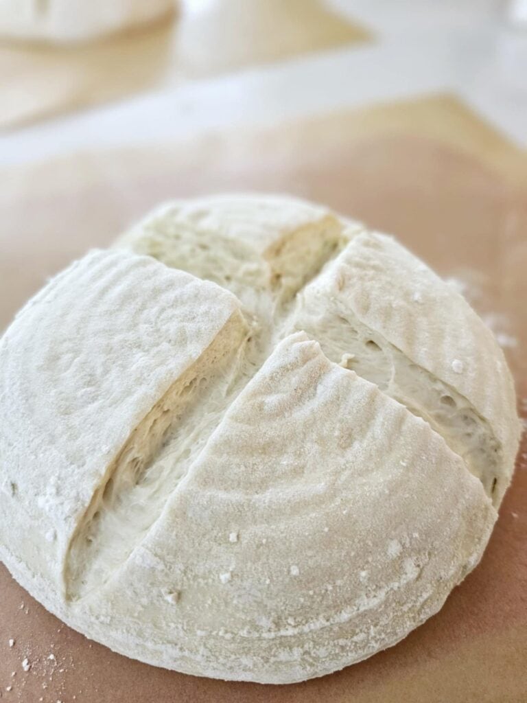 Raw shaped sourdough with the crisscross score pattern