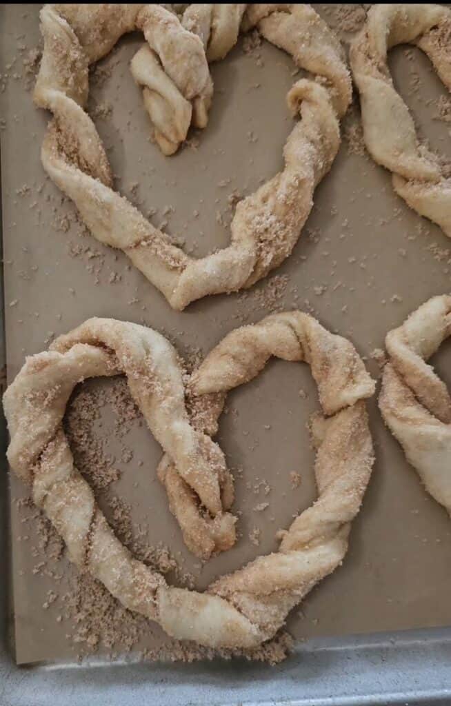 Raw dough in the shape of a heart sprinkled in cinnamon sugar