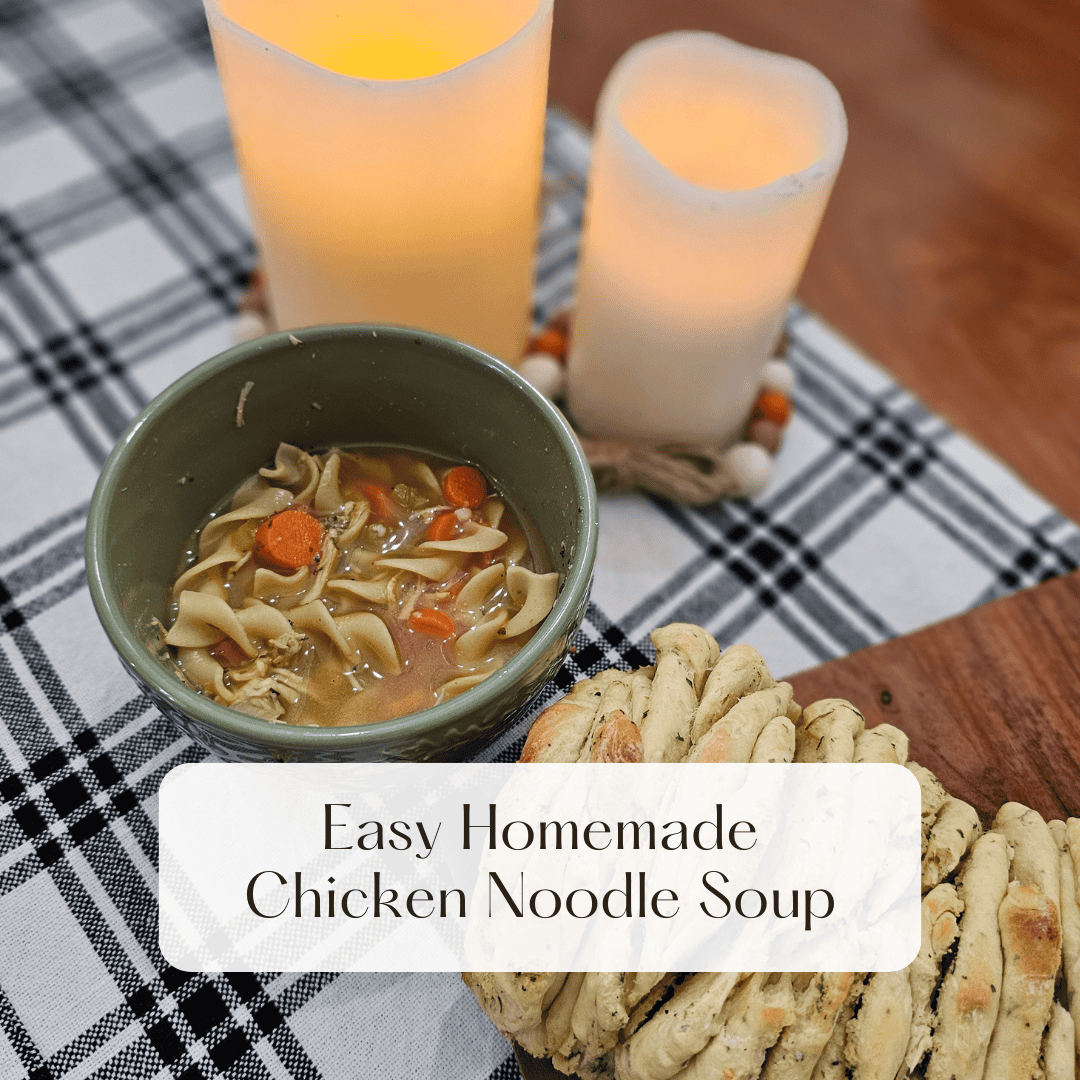homeade chicken noodle soup in a green bowl on a checkered table cloth