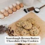 A dozen eggs in a glass egg dish, spilled chocolate chips, sourdough brown butter chocolate chip cookies