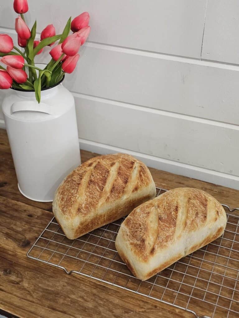 2 loaves of traditional sourdough sandwich bread. Pictured with a tulip arrangement.